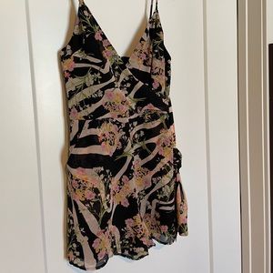 Brand new. Never worn. Guess Romper. Tags attached. Zipper in back.